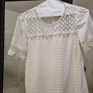 Cream colored blouse 👚 with pearls.